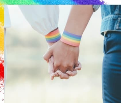 虹色のリストバンドをした二人が手を繋いだ画像で、性別を問わない結束の強さを表現している